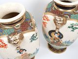 two vases that have been decorated with asian designs