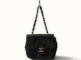 a black chanel bag with a chain hanging from it