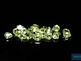 a bunch of green diamonds on a black surface
