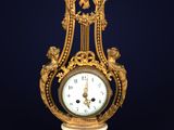 an image of a gold and white clock on a stand