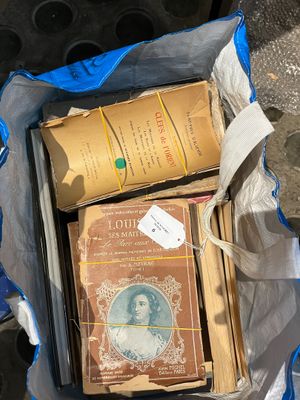 un sac rempli de vieux livres posé par terre