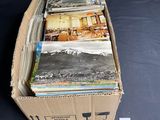 a cardboard box full of books on a black surface