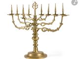 a large brass candelab with five candles on a stand