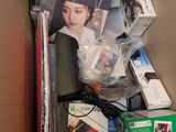 a cardboard box filled with electronic equipment and other items