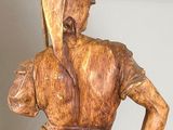 wooden statue of a man with a spear in his hand