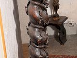 a statue of a bird on a pedestal in a room