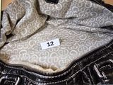 a black and white purse with a price tag on it