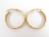 two pairs of gold hoop earrings on a white background