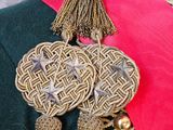 a close up of a coat with a tassel on it