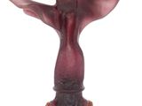 un vase rouge surmonté d'un oiseau