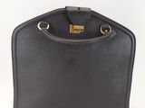 a black leather handbag with a gold clasp on the handle