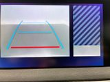 a picture of a car ' s dashboard with a picture of a tennis court on the screen