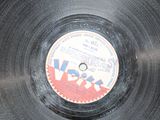 vinyl record on a black surface with a red and blue label