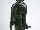 an image of a statue of a woman in a green dress