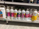 many bottles of cleaning products on a shelf in a store