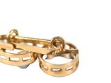 a pair of gold rings that are on top of each other