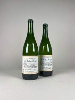 two bottles of wine sitting next to each other on a table