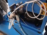 une machine bleue à laquelle est raccordé un tuyau