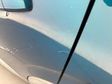 a close up of a car door with a stick sticking out of it ' s side