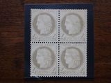 a close up of four stamps on a wooden surface