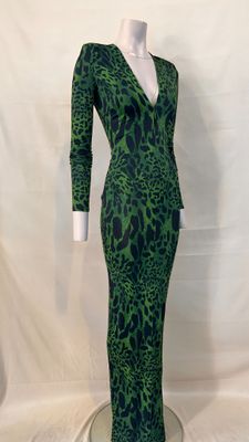 a green and black leopard print dress on a mannequin base