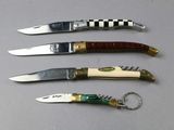 four different types of knives are lined up on a table