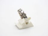 a ring with a diamond on it on top of a stand