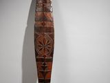 an old wooden paddle with a decorative design on it