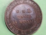 a close up of a coin on a table with a green background