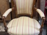 a chair that is sitting in a room next to a red chair