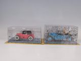 two toy cars that are in a display case