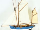 a model of a boat with sails on a stand