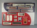a red and white box with a train set inside of it