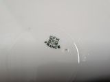 a close up of a white plate with a black design on it