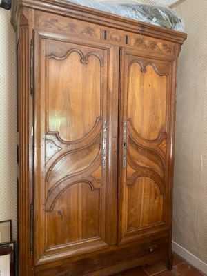 a large wooden cabinet with a mirror on top of it