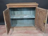 an old wooden cabinet with a door open on the floor