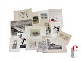 a pile of old photographs and postcards on a table