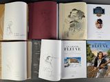 several books are lined up on top of each other on a table
