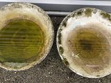 two dirty pots sitting on the ground next to each other