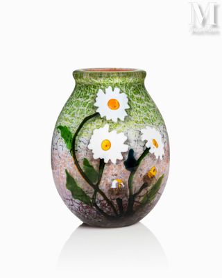 a vase with flowers painted on it sitting on a table