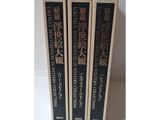 three books are stacked on top of each other on a table