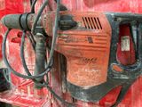 a drill that is sitting on the side of a red box