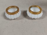 pair of white and gold candlestick holders with gold rims