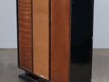 an image of a black and orange cabinet with a wooden paneled door