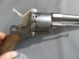 a person holding a gun that is on a table