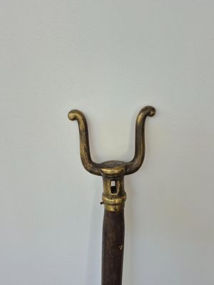 a metal handle with a wooden handle attached to it