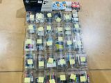 a lot of ink cartridges in a box on the floor