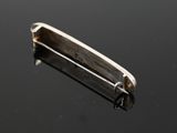 a close up of a small metal object on a black surface