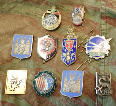 a lot of badges that are on a military uniform