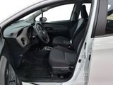 the interior of a car with the door open and the driver ' s seat down
